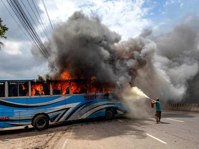 Bangladesh Nationalist Party (BNP) activists set a bus on fire as they blocked a highway in Dhaka in a protest calling for Prime Minister Sheikh Hasina's resignation. Picture: AFP