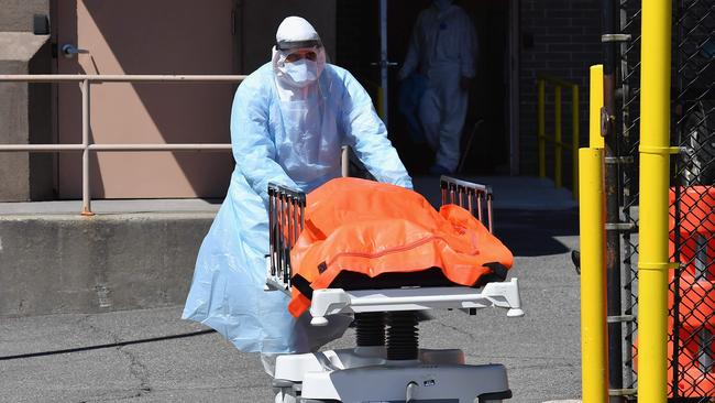 Medical staff move bodies to a refrigerated truck in Brooklyn. Picture: AFP.