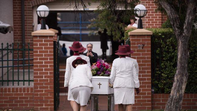 Lilie's white coffin is taken inside Danebank College. Picture: NCA NewsWire / Flavio Brancaleone