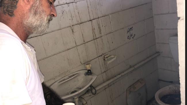 Guardian Angel Ed Hornery inside the disgusting toilet which has now been ripped down.