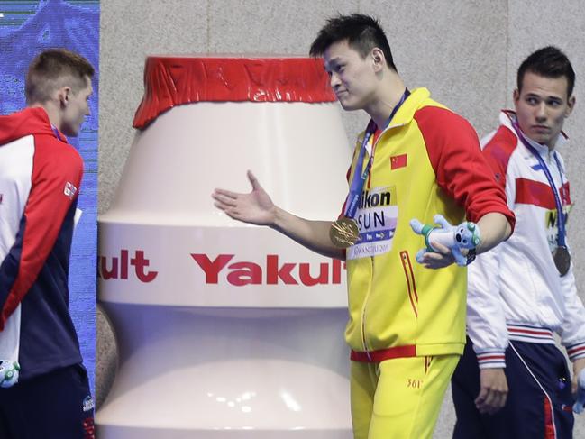 Sun Yang (centre) was seen goading Duncan Scott (left) after he followed Mack Horton’s lead and refused to stand on the podium with him. Picture: AP/Mark Schiefelbein