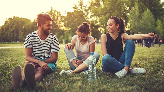 Three beautiful friends sitting in the park,laughing and having a great time. Picture: iStock