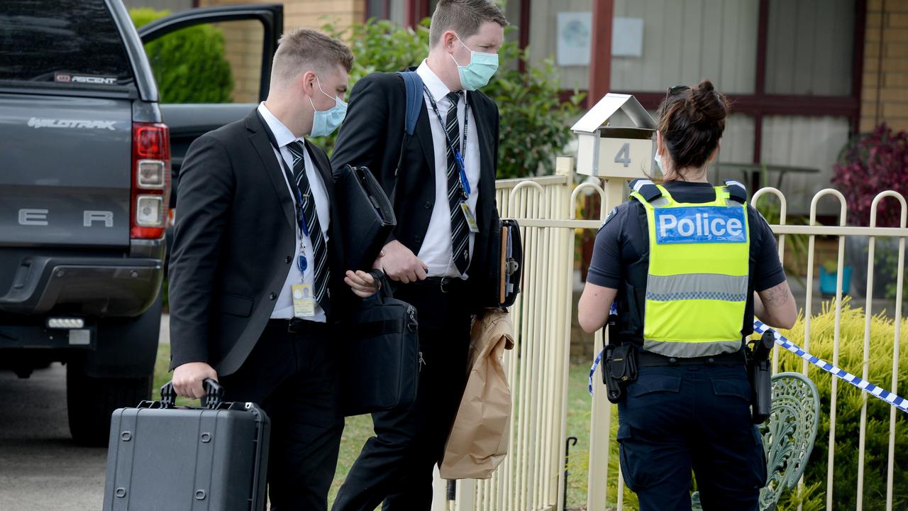 Detectives remove evidence bags on Friday from the Tullamarine home. Picture: Andrew Henshaw