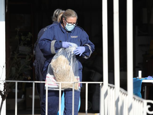 Police remove items from the Hilgay St home. Picture: David Crosling