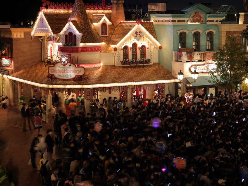 Tourists wait to get tested for Covid-19 at the exit of the Disneyland in Shanghai, China late Sunday, Oct. 31, 2021.