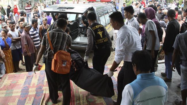 Indonesian police officers carry the body of a victim who drowned after a boat capsized in Batam, Indonesia. Picture: AP/M Urip