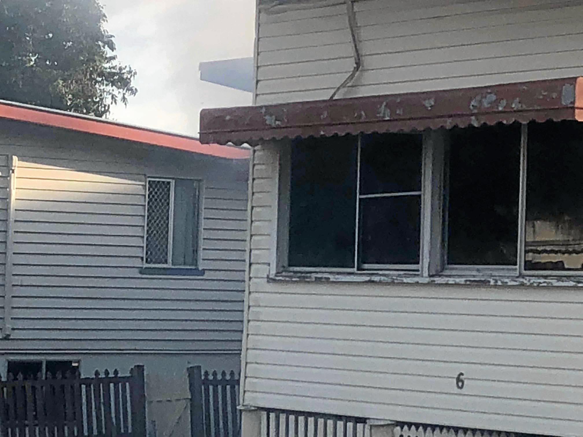 Firefighters at the scene of a house fire on Naughton St, Wandal, this afternoon. Reports indicate the top part of the house is gutted but firefighters are walking in through the front door.