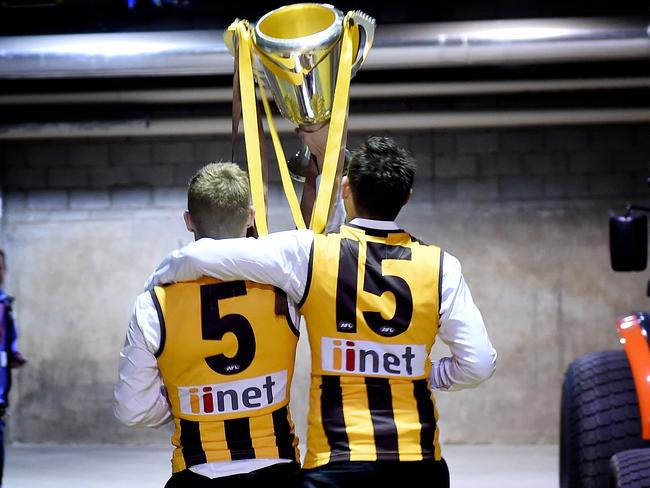 Sam Mitchell and Luke Hodge in the car park of the MCG with the 2014 AFL premiership Cup. 2014 AFL Grand Final match between Hawthorn Hawks and the Sydney Swans at the MCG Melbourne Cricket Ground on September 27, 2014. AFLGF2014 Picture: Nicole Garmston HS25