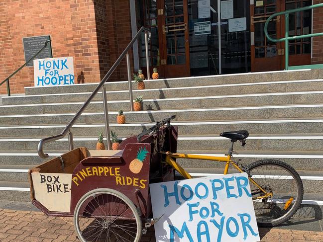 Chris Hooper and his friends have set a display of pineapples and his Pineapple Express bike out the front of the Rockhampton Regional Council office.