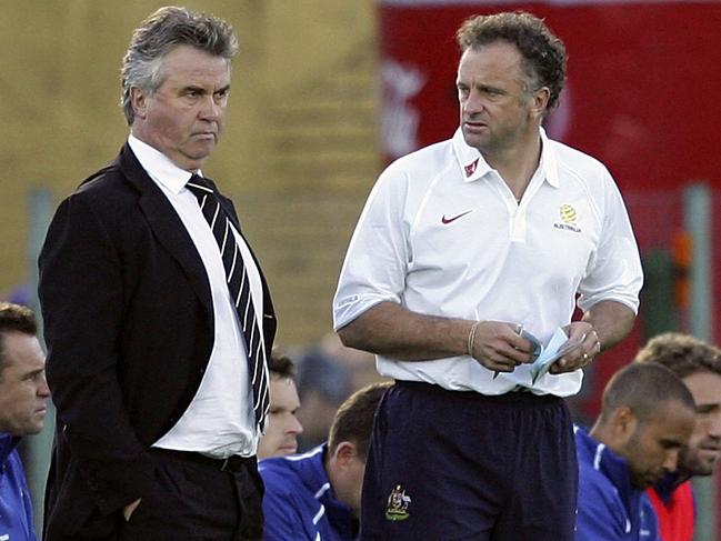 Hiddink (L) talks with then assistant Graham Arnold during the first leg of the 2006 World Cup playoff against Uruguay. Picture: Robert Cianflone/Getty Images