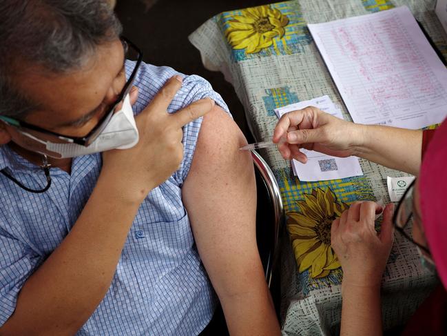 A man receives a dose of Pfizer COVID-19 coronavirus vaccine at a health center in Jakarta on February 1, 2023. (Photo by BAY ISMOYO / AFP)