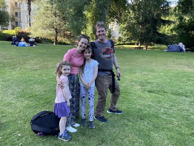 Mary Cullen and Lachlan Carter &amp; kids at Treasury Gardens in the Melbourne CBD for the 2024 New Year's Eve fireworks. Picture: Gemma Scerri