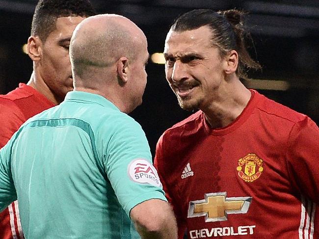 Manchester United's Swedish striker Zlatan Ibrahimovic (R) remonstrates with English referee Lee Mason (2R), after Mason disallowed his goal, as Middlesbrough's Spanish goalkeeper Víctor Valdes (2L) receives medical treatment during the English Premier League football match between Manchester United and Middlesbrough at Old Trafford in Manchester, north west England, on December 31, 2016. / AFP PHOTO / Oli SCARFF / RESTRICTED TO EDITORIAL USE. No use with unauthorized audio, video, data, fixture lists, club/league logos or 'live' services. Online in-match use limited to 75 images, no video emulation. No use in betting, games or single club/league/player publications. /