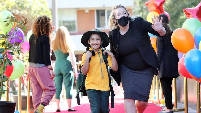 Deputy principal Jenna Arzapitian welcomes Dakshanya back to school. Picture: Richard Dobson