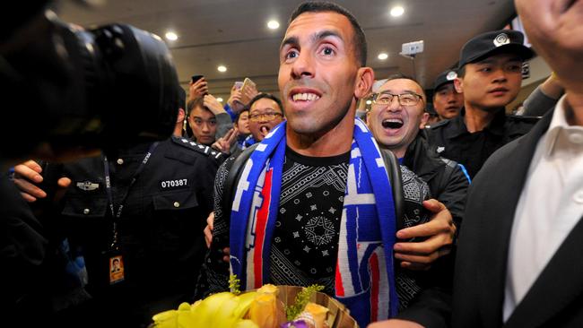 Argentine striker Carlos Tevez makes his way through the arrivals halls at Shanghai International Airport.