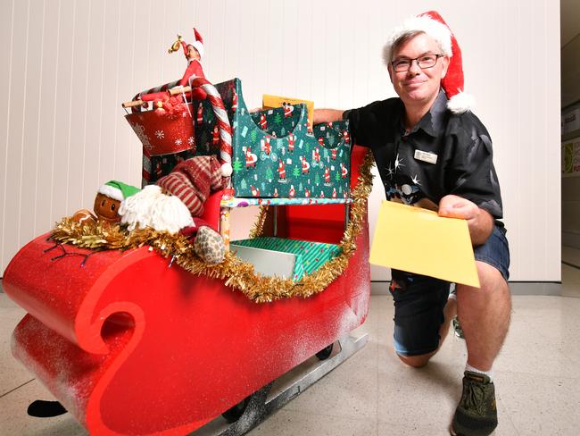 Colin Paine the mailman at the Townsville University Hospital has decorated his trolley as a Christmas Sleigh. Picture: Alix Sweeney