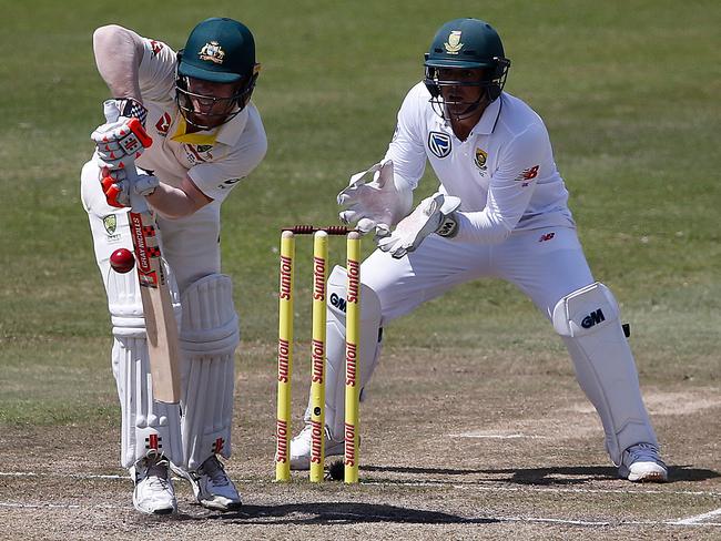 David Warner (L) bats as Quinton de Kock keeps in the first Test.