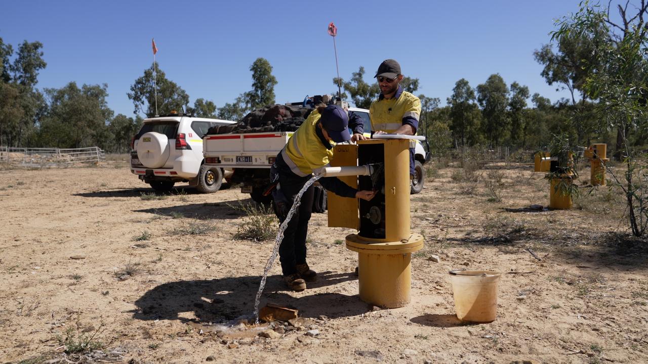 Workers at a monitoring bore