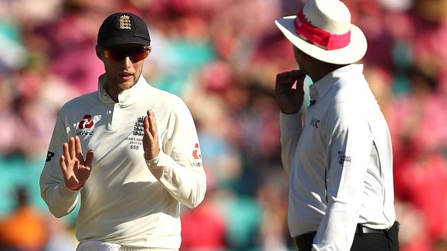 Joe Root speaks to the umpire.