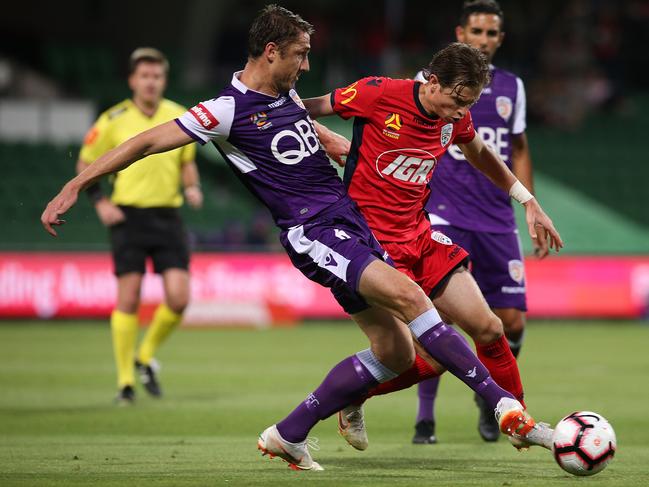 Craig Goodwin battles for the ball with Dino Djulbic during Adelaide United’s draw with Perth Glory. Picture: Paul Kane/Getty Images