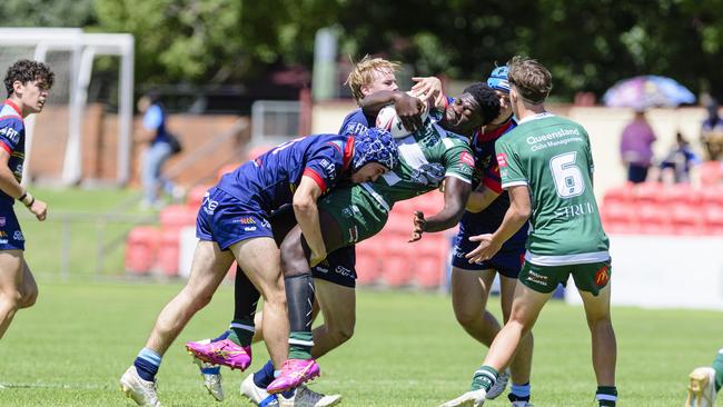 Innocent Baruani of Ipswich Jets keeps possession in a tackle from Western Clydesdales. Picture: Kevin Farmer