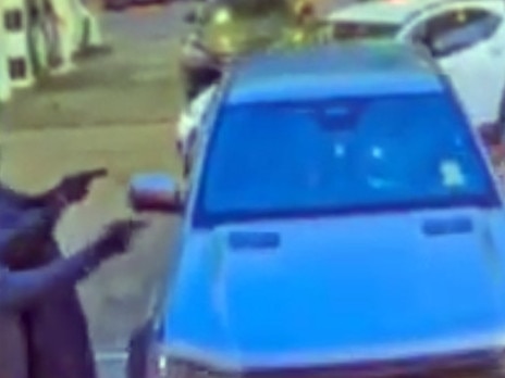 Gunmen take aim as the crime figure dashes from vehicle. Picture: Supplied.