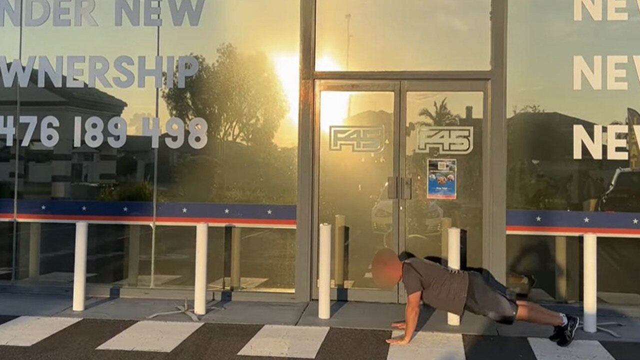 A customer doing a push-up out the front of a shutdown F45 gym.