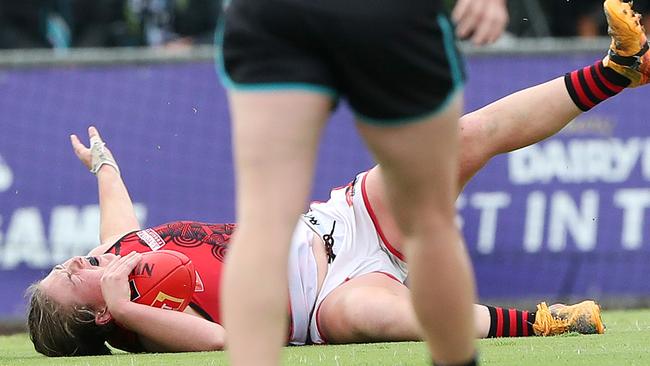 Lily-Rose Williamson grimaces in pain after landing badly in a tackle at Alberton Oval. Picture: Sarah Reed/AFL Photos via Getty Images