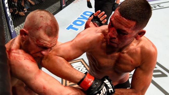 Nate Diaz (R0 lands an elbow on Conor McGregor’s head.