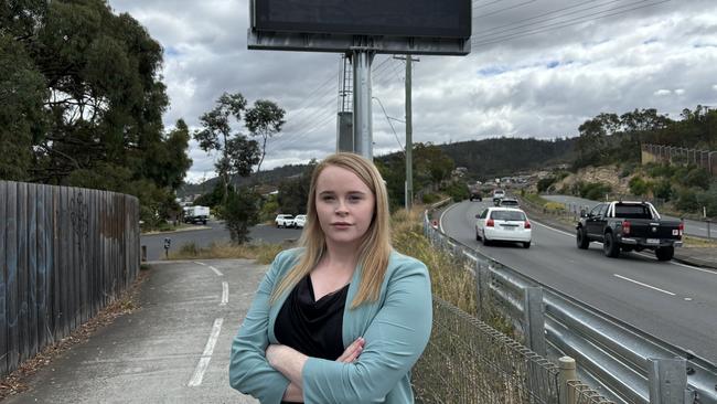 Labor transport spokeswoman Meg Brown in front of a blank electronic traffic sign on the South Arm Highway. Picture: Simon McGuire.