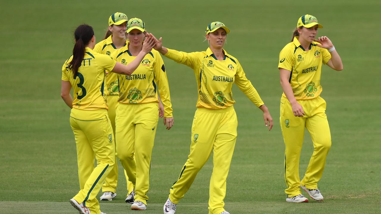 The Aussies celebrate one of Megan Schutt’s four wickets. (Photo by Mike Hewitt/Getty Images)