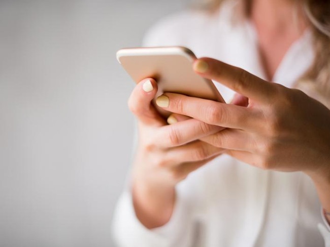 Close up of a woman using her smartphone indoors. generic. istock