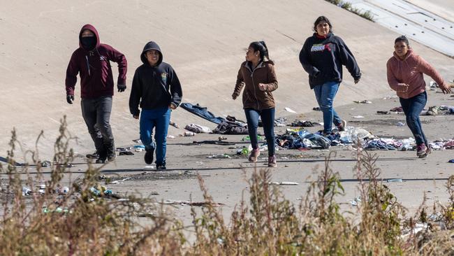 Immigrants run towards a US Border Patrol checkpoint after crossing the Rio Grande into El Paso, Texas, on Monday. Picture: Getty Images