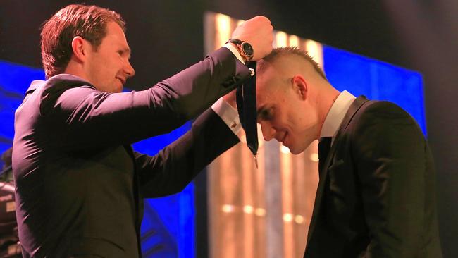 Dustin Martin accepts the AFL 2017 Brownlow Medal from Patrick Dangerfield. Picture: Mark Stewart