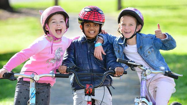 Indiana, 8, Mustafa, 7, and Giselle, 7, give bike riding a thumbs up. Picture: Nicki Connolly