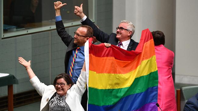 Crossbenchers Cathy McGowan, Adam Brandt and Andrew Wilkie celebrate the passing of the Marriage Amendment Bill in the House of Representatives at Parliament House in Canberra, Thursday, December 7, 2017. Picture: AAP/Mick Tsikas.