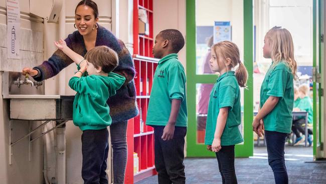 Prep teacher Kathryn Axisa teaches prep students Oscar, Michael, Ella and Hildie to wash their hands. Picture: Jake Nowakowski