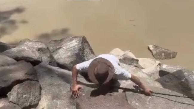 He staggers backwards almost falling into the croc-infested water but manages to turn himself around. Picture: Jody Chisholm