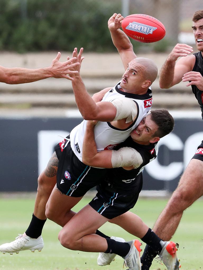 Sam Powell-Pepper fires out a handpass after being caught in Zak Butters tackle. Picture: Sarah Reed