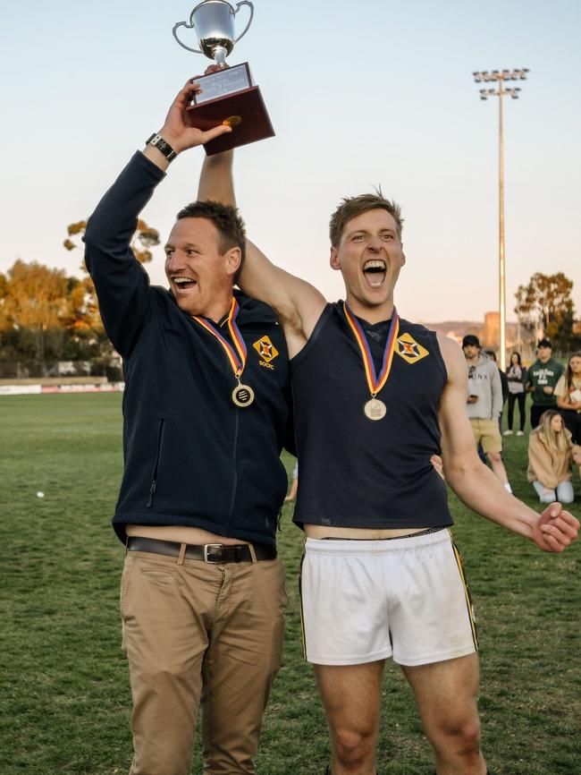 Scotch coach Kym Cobb and captain Lachlan Giles lift the division three premiership trophy in 2018. Giles has returned after a season away. Picture: AAP/Morgan Sette