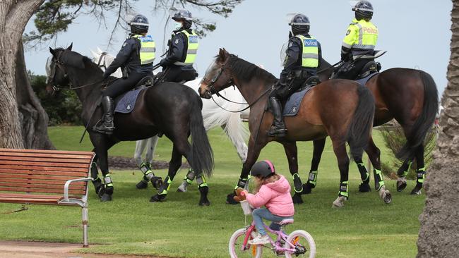 Mounted police patrol through St Kilda. Picture: David Crosling