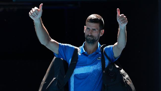 Grace of a champion … despite the booing of the crowd, Novak Djokovic gave a thumbs up as he retired hurt. Picture: Getty Images