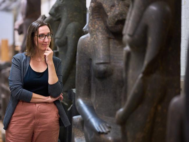 Dr Marie Vandenbeusch examines the Sekhmet statues. Picture: Josh Caius