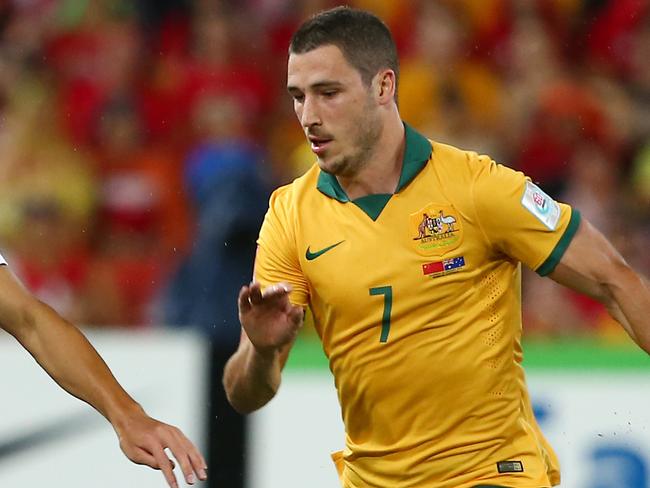 China's Zhang Chengdong takes the ball past Australia's Mathew Leckie during the AFC Asia Cup quarterfinal soccer match between China and Australia in Brisbane, Australia, Thursday, Jan. 22, 2015. (AP Photo/Tertius Pickard)
