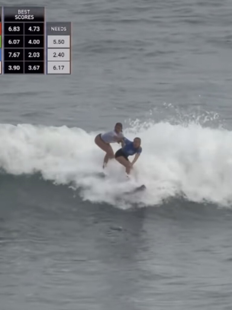 A Portugal surfer (left) tries to push Aussie Willow Hardy (right) off her board. Photo@surfingrepublica