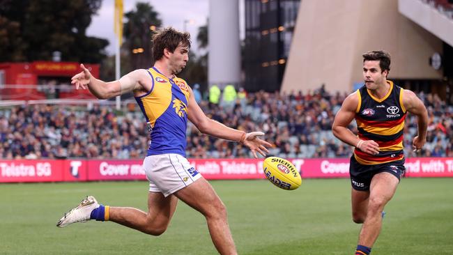 ADELAIDE, AUSTRALIA – JULY 18: Andrew Gaff of the Eagles kicks the ball past Darcy Fogarty of the Crows during the 2021 AFL Round 18 match between the Adelaide Crows and the West Coast Eagles at Adelaide Oval on July 18, 2021 in Adelaide, Australia. (Photo by Sarah Reed/AFL Photos via Getty Images)