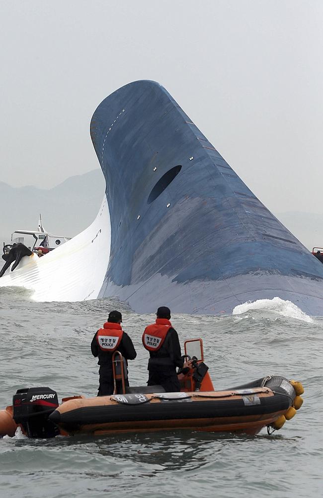 The scene of the incident ... South Korean coast guard officers try to rescue passengers from ferry Sewol in the water off the southern coast near Jindo, Picture: Hyung Min-woo, Yonhap