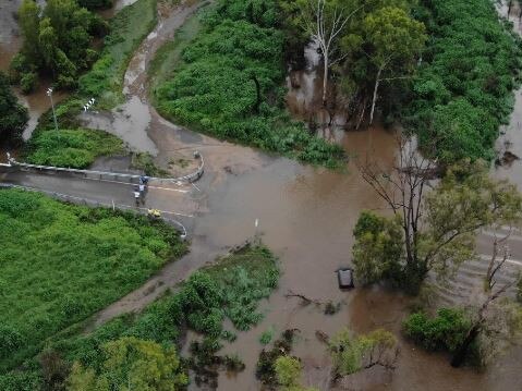 A car is washed off the road at McLeod River Crossing, Mt Carbine. Picture: QFES