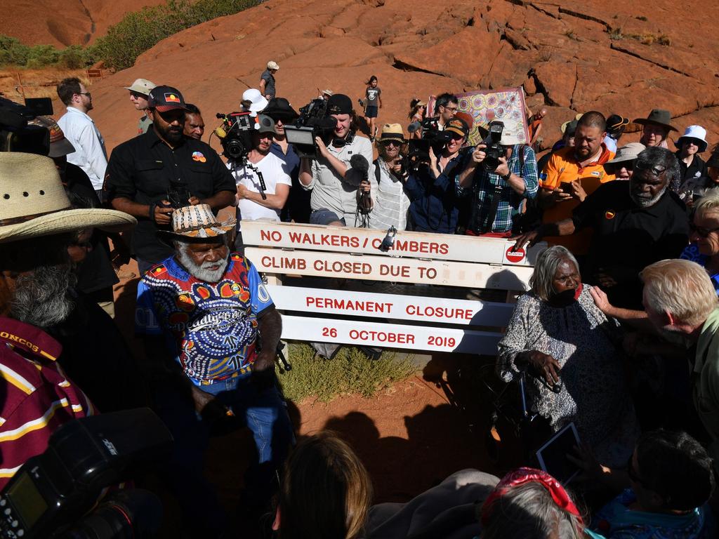 Aboriginal elders (L) gather for a ceremony ahead of a permanent ban on climbing Uluru that comes into place on October 26. Picture: Saeed KHAN / AFP.