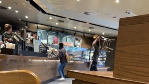 The moment a man attacked a Starbucks counter with a chair. Picture: TikTok / caradnopal